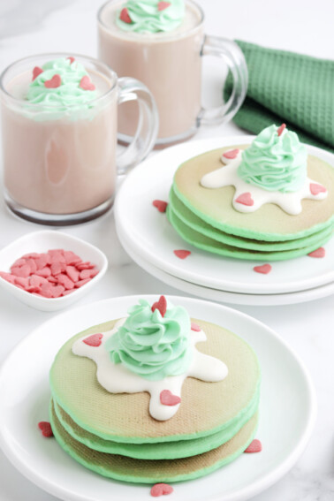 Copycat IHOP Grinch Pancakes - Green pancakes with green whipped cream and heart -shaped sprinkles - Kids Activities Blog