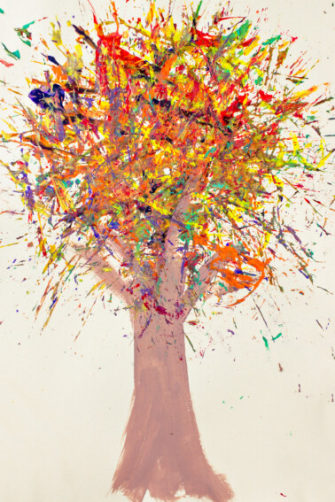 a colorful fall tree painted using pine needles and acrylic paint