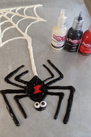 Finished spider gel cling craft next to supplies - Kids activities blog