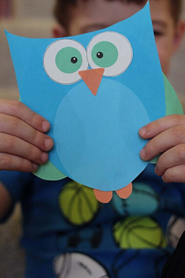 preschool owl craft with printable template finished and held by child