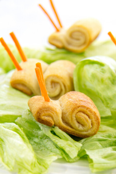 snail snacks for kids made out of crescent roll dough and carrots