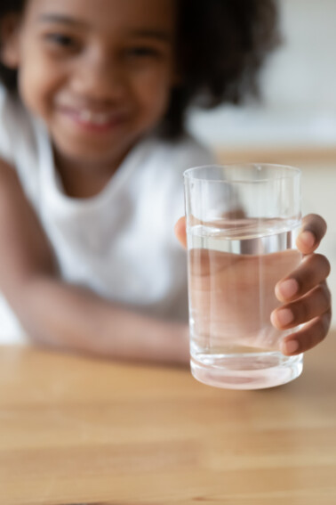Water Absorption Experiment for Kids - Kids Activities Blog - child with glass of water in hand
