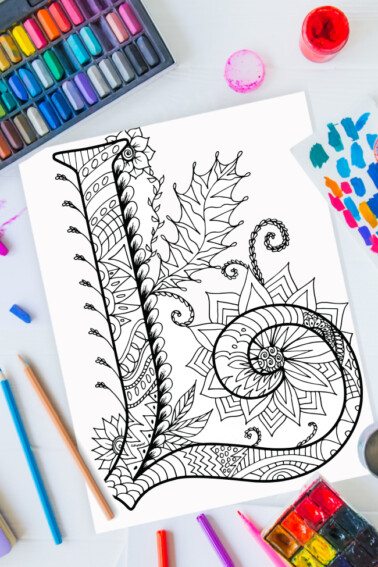 Zentangle alphabet coloring pages - letter l zentangle design on background of paint, colored pencils and art supplies