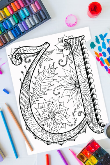 Zentangle alphabet coloring pages - letter u zentangle design on background of paint, colored pencils and art supplies