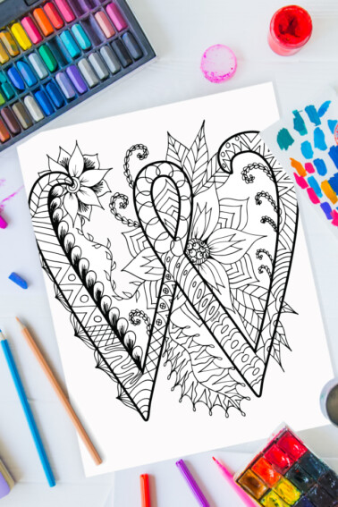 Zentangle alphabet coloring pages - letter w zentangle design on background of paint, colored pencils and art supplies