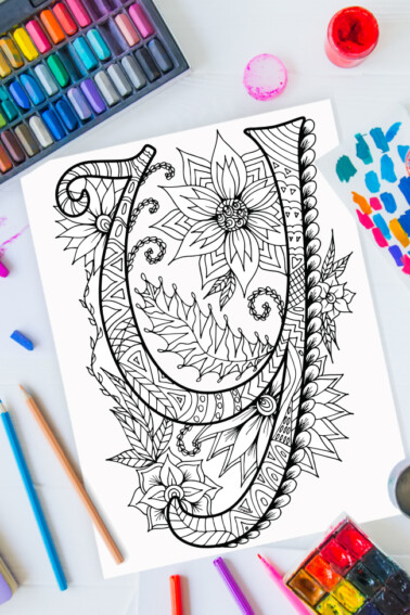 Zentangle alphabet coloring pages - letter y zentangle design on background of paint, colored pencils and art supplies