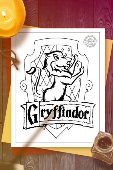 Gryffindor crest coloring page on red and yellow construction paper on a wooden surface with candle, inkpot and quill, Harry Potter glasses and shadow of someone waving a magic wand