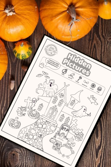 Halloween hidden pictures coloring page activity on a wood table surrounded by small pumpkins